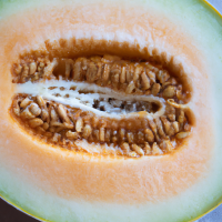fresh cut cantaloupe in half in full view shown from short distance