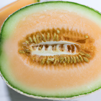 fresh cut cantaloupe in half in full view shown from short distance